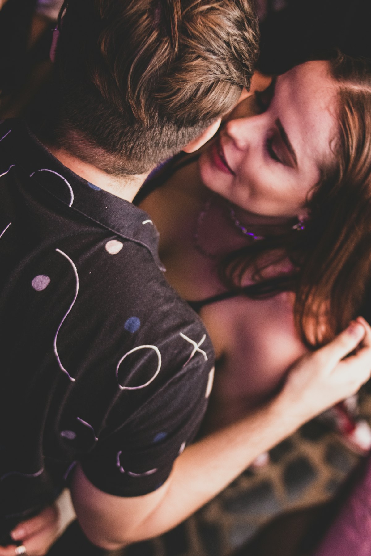 A couple moving gently toward each other, taking their time to connect